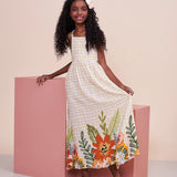 Vestido longo feminino infantil com estampa floral colorida e fundo xadrez