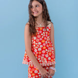 Macacão floral vermelho com alças largas e detalhes em flores brancas, feminino infantil.