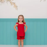 Conjunto infantil feminino com blusa vermelha de alças e short leve, detalhes em babados