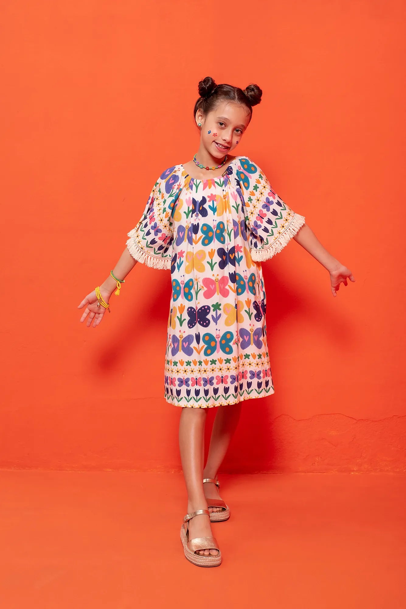 Vestido midi infantil com estampa de borboletas coloridas e franjas na barra