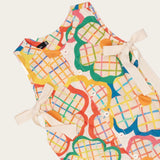 Macaco infantil feminino com estampa de flores coloridas em fundo xadrez