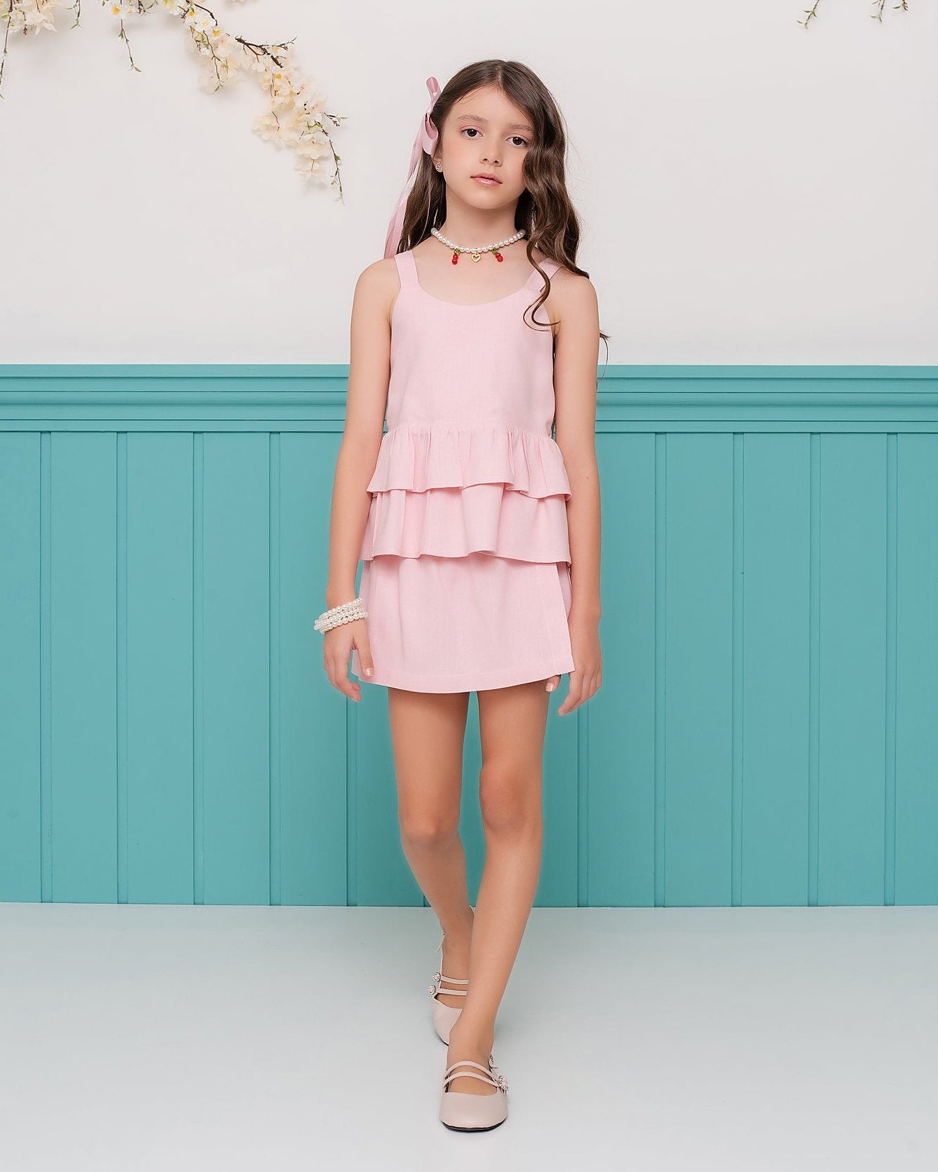 Conjunto feminino infantil com blusa de alças largas e saia curta, detalhes em camadas