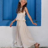 Conjunto feminino infantil com blusa de alças largas e calças amplas em tom claro, detalhe de amarração