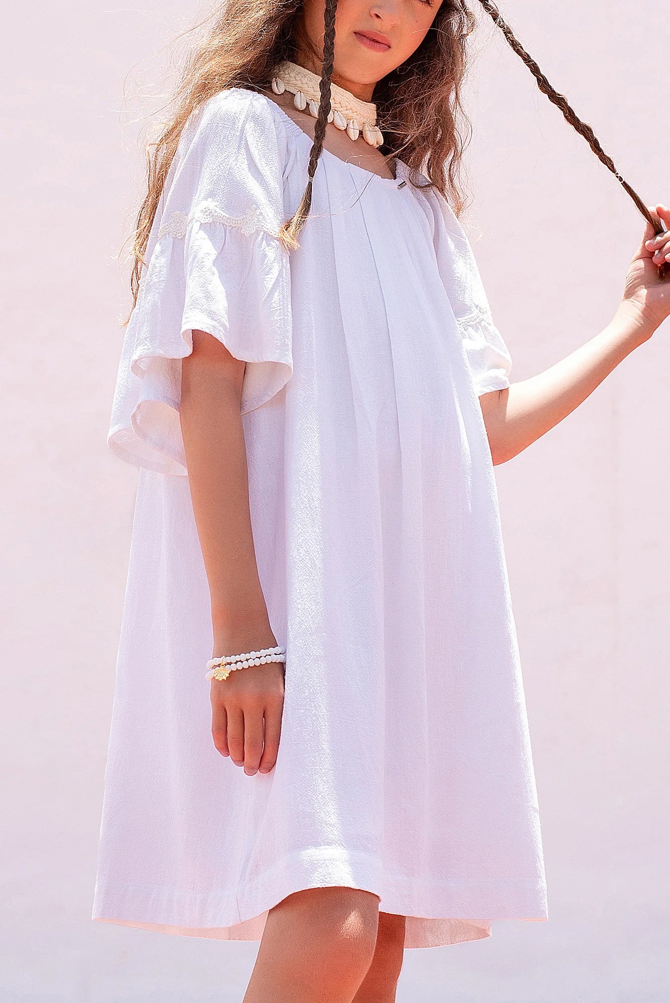 Blusa infantil branca com mangas bufantes e gola arredondada, ideal para looks leves