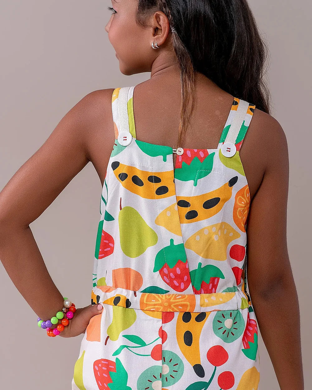 Jardineira infantil com estampa de frutas coloridas e alças largas