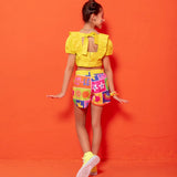 Conjunto infantil feminino com blusa amarela e short colorido estampado com formas geométricas e flores